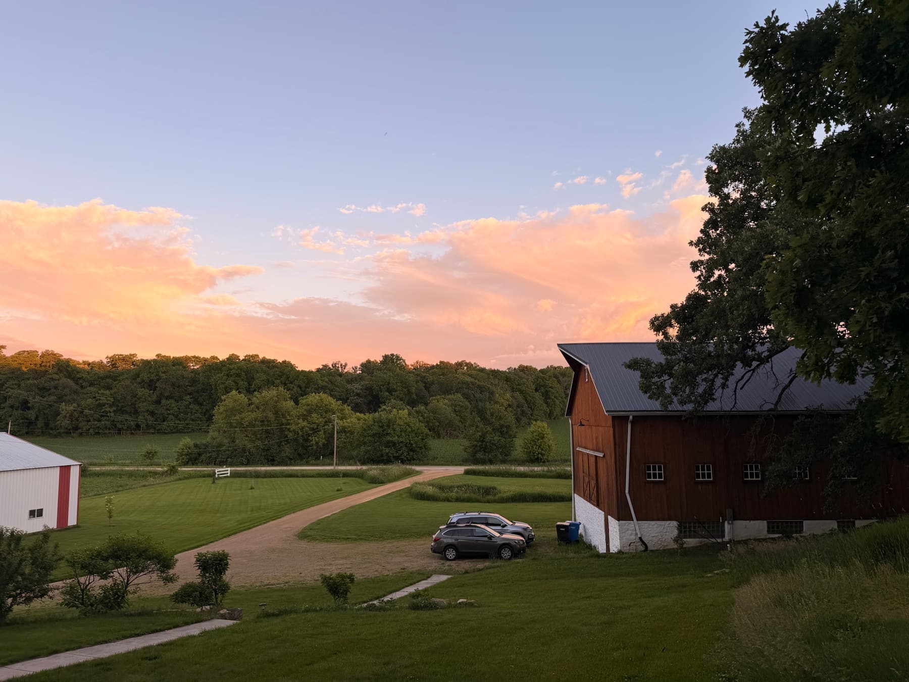 The family farm at dusk under a pink and blue sky